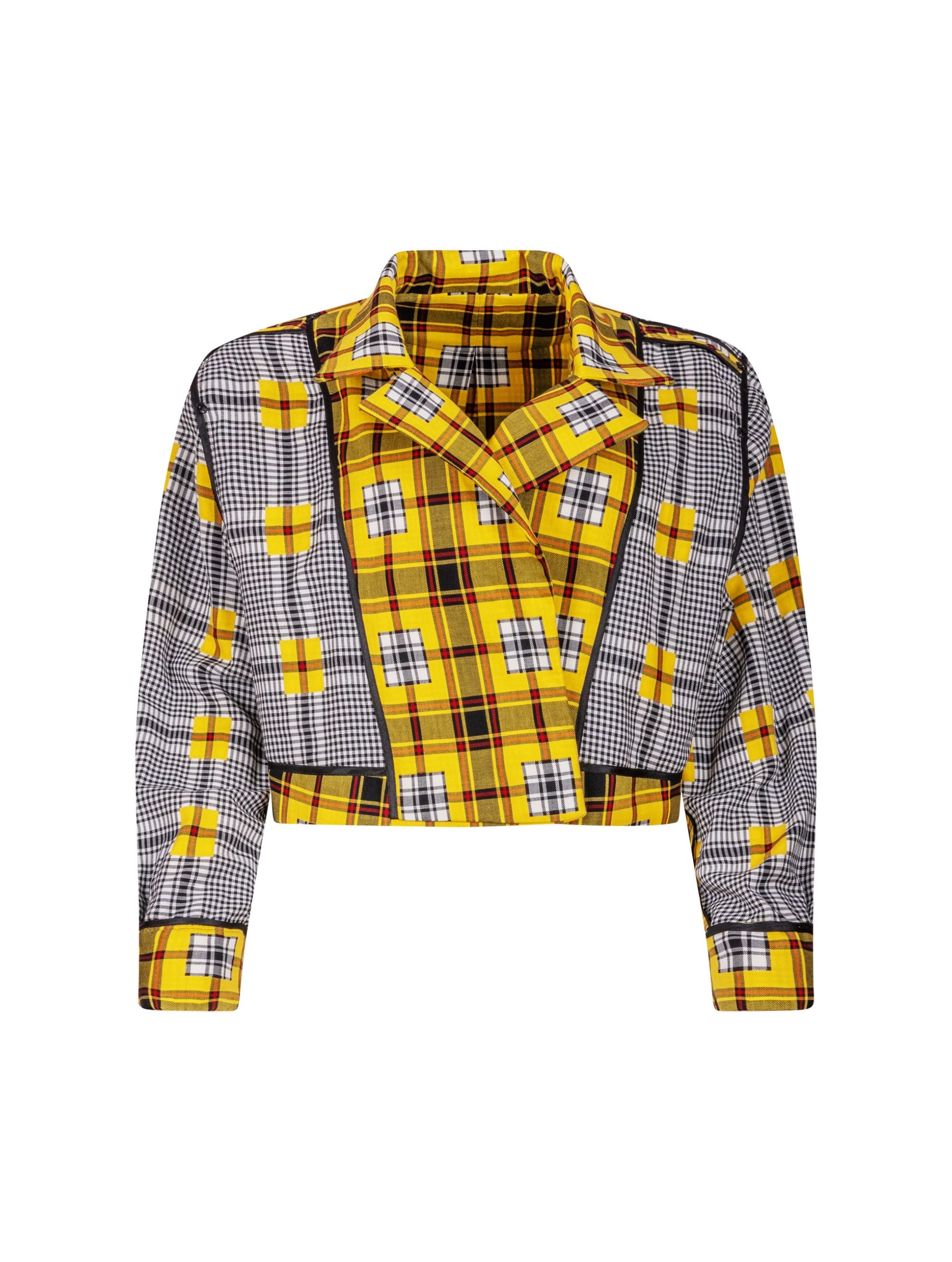 Doppelseitige Karo-Kurzjacke mit abnehmbaren Schulterpolstern, eingesetzten Ärmeln mit Ärmelgürteln und Schulterklappen sowie vorderen Halbpasse. Die Jacke kann von beiden Seiten getragen werden. Hergestellt aus Naturfasern.