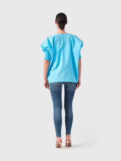 Locker sitzende Bluse mit elastischen Bündchen an den Ärmelenden. 