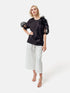 Bluse mit Rundhalsausschnitt, Organza-Ärmeln, sowie Bluemnapplikationen und kleinen
Seitenschlitzen. Versteckten Seitentaschen in der Seitennaht. Dieses Produkt ist Teil unserer Reborn Linie.