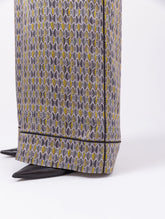 Bedruckte Satin-Seidenhose mit weitem Bein im Pyjama-Stil, elastischem Bund, Seitentaschen und schwarzen Paspeln. Hergestellt aus Naturfaser.