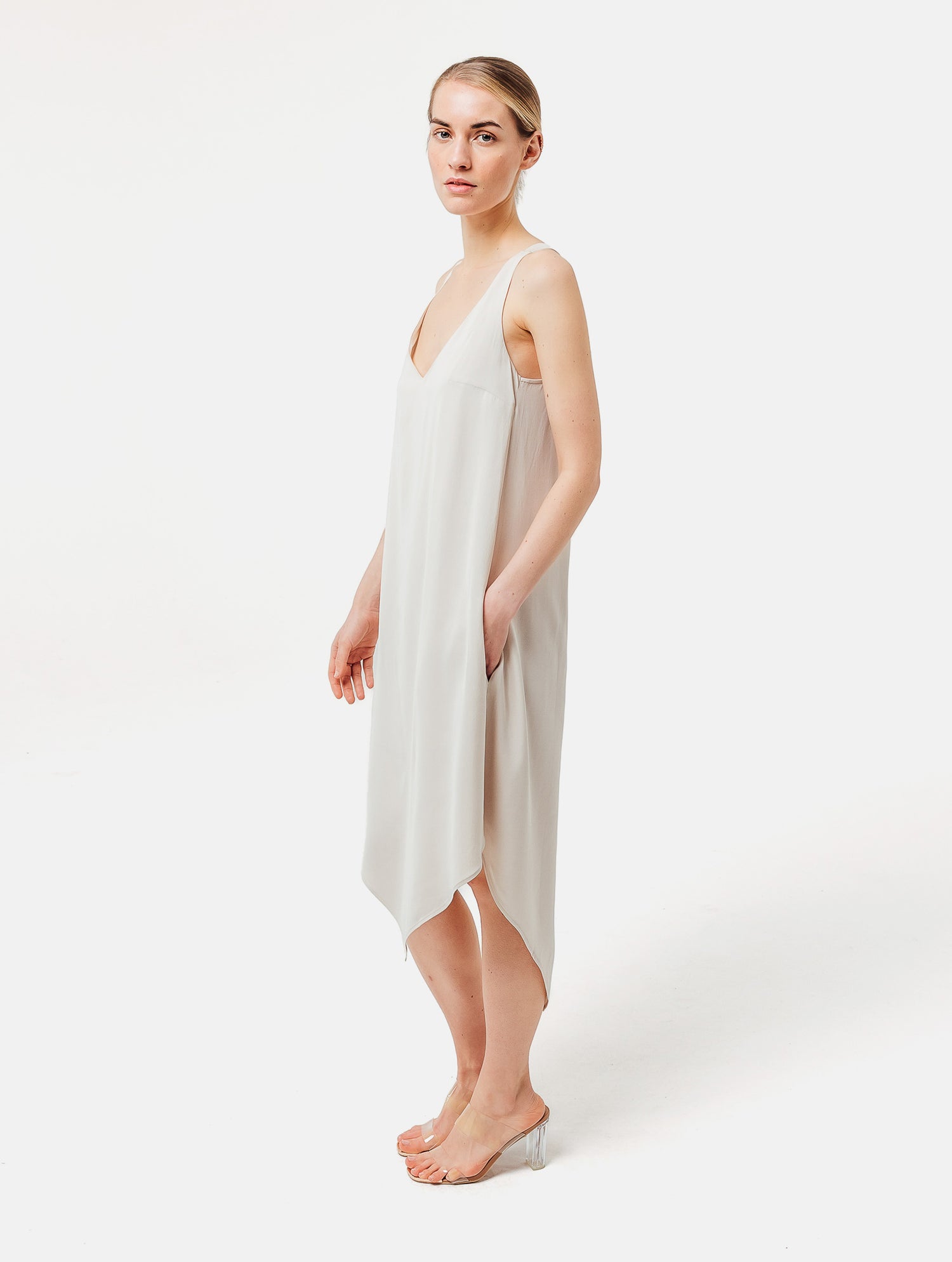 Zeitloses Trägerkleid aus fließender Satinseide mit tiefem V-Ausschnitt und spitz zulaufend für eine raffinierte Silhouette.